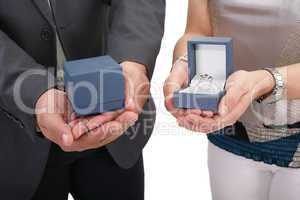 couple hands holding boxes with rings. valentines day and engage