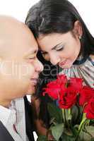 close up of couple holding a bouquet of red roses