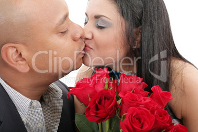 close up of couple kissing holding a bouquet of red roses