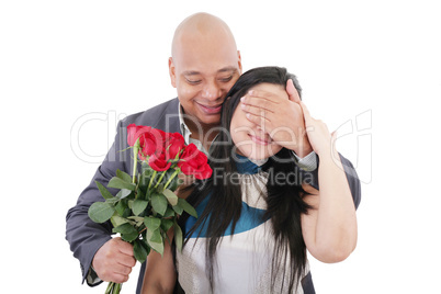 man offering a bouquet of red roses to a woman