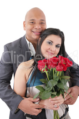 portrait of happy couple with flowers, looking at camera.