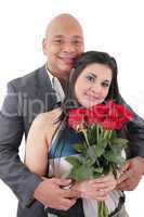 portrait of happy couple with flowers, looking at camera.