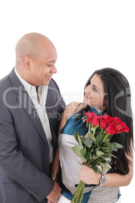 young couple with bouquet of roses looking at each other