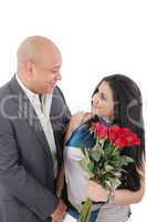 young couple with bouquet of roses looking at each other