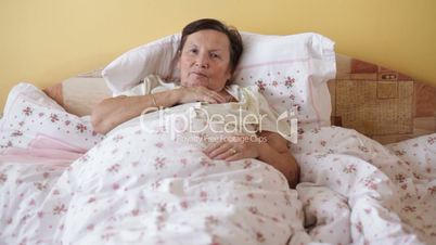 Ill senior woman with thermometer