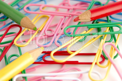colored paper clips on white