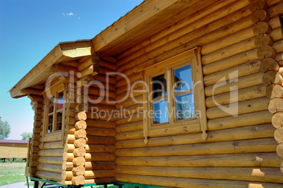 Wall of a wooden house with windows.