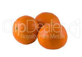 three ripe oranges on a white background