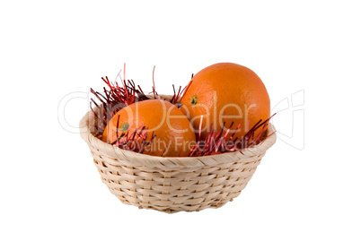 wum basket with ripe oranges on a white background