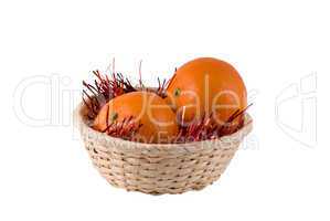 wum basket with ripe oranges on a white background