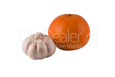 garlic and ripe orange on a light background