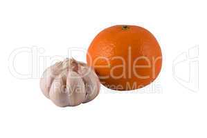 garlic and ripe orange on a light background