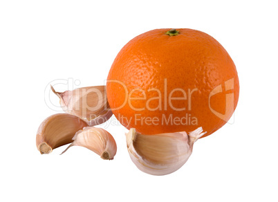 segments of garlic and a ripe orange on a light background