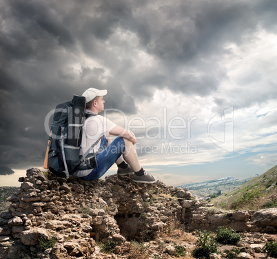 Tourist sitting on the rocks