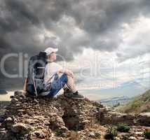 Tourist sitting on the rocks