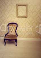 antique upholstered chair in a wallpapered room