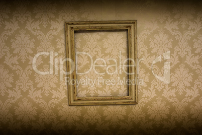 empty antique frame hanging on wallpaper