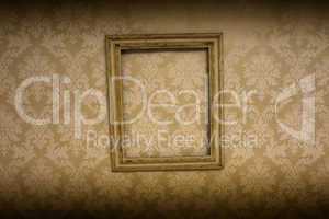 empty antique frame hanging on wallpaper