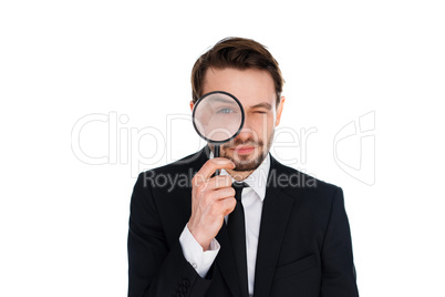 businessman looking through a magnifying glass