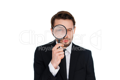 businessman looking through a magnifying glass