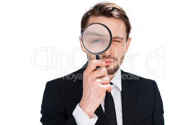 businessman looking through a magnifying glass