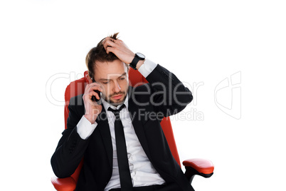 worried businessman chatting on his mobile