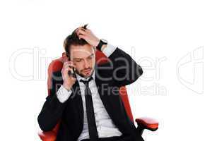 worried businessman chatting on his mobile