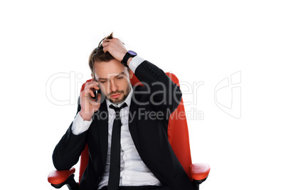 worried businessman chatting on his mobile