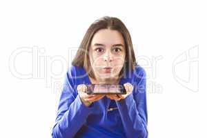 teenage girl blowing icons from digital tablet