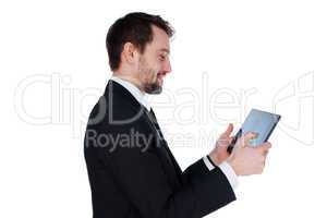 smiling businessman looking at his tablet-pc