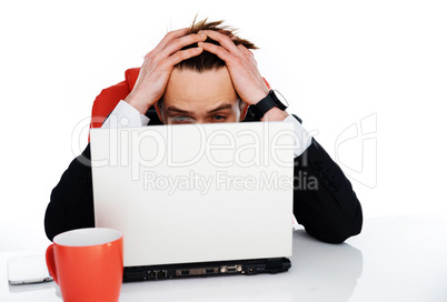 worried businessman holding his head in his hands