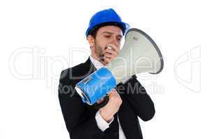 businessman wearing a hardhat holding a megaphone
