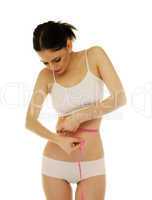 slim woman measuring her waistline