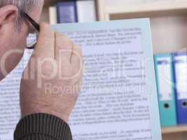 man with glasses looking at screen