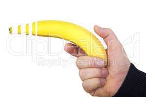 hand holds banana as a gun