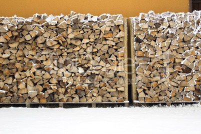 stacked and snowy firewood