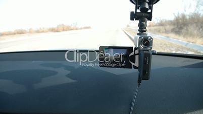 Parked car with recording DVR on windshield