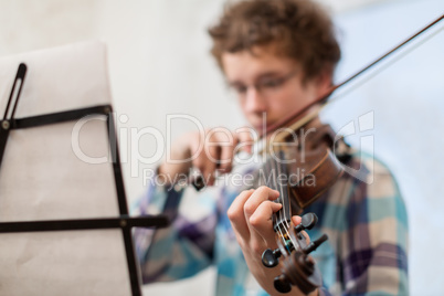 The boy of the house plays a violin