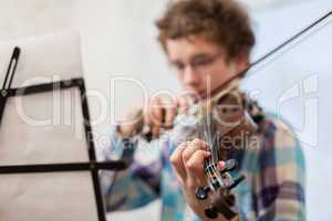The boy of the house plays a violin