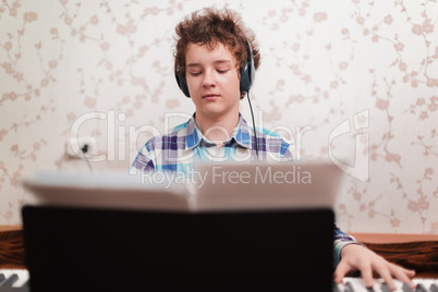 boy plays piano