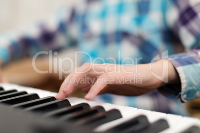 Hands playing the piano (close-up)