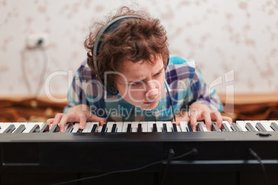 boy plays piano