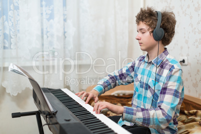 boy plays piano