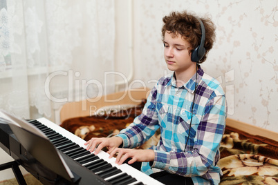 boy plays piano