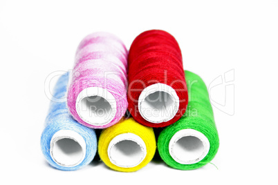 multi-colored threads on a white background