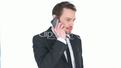 Puzzled businessman talking on a mobile
