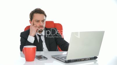 Serious businessman working at his laptop
