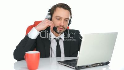 Handsome call centre operator taking a call