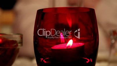 A candlelight inside a red glass