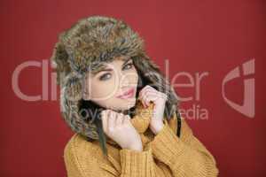 beautiful young girl in a furry winter hat